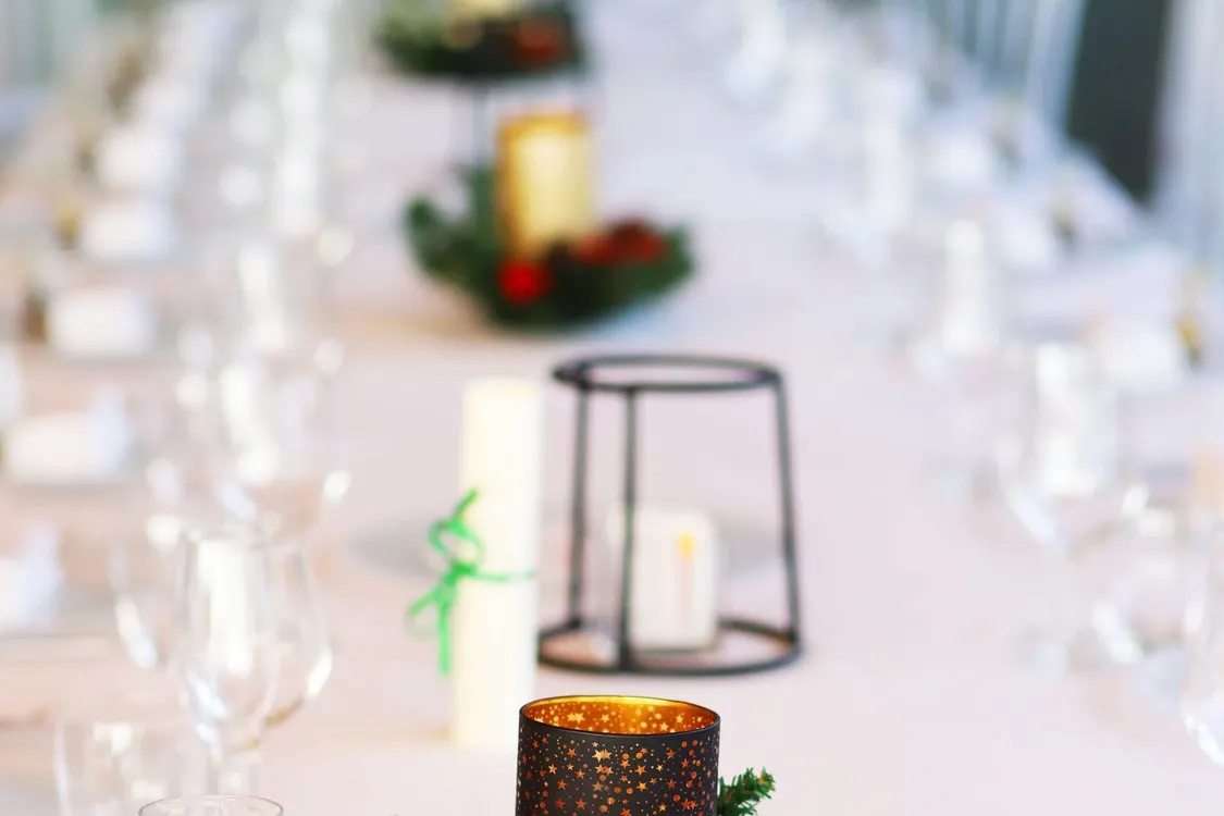 Elegant long dinner table set with festive candle centerpieces