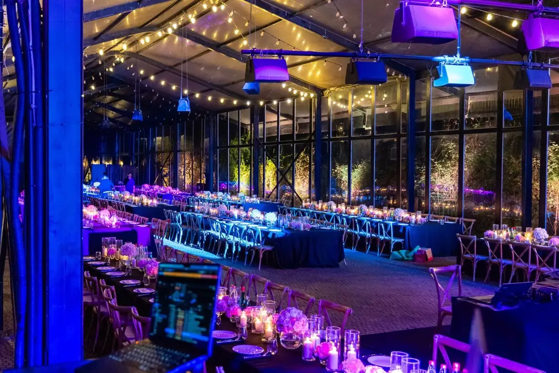 DJ booth overlooking an elegantly lit formal dinner event